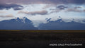 Wide glacial outwash plain with ice and dark volcanic sand under heavy cloud, Iceland