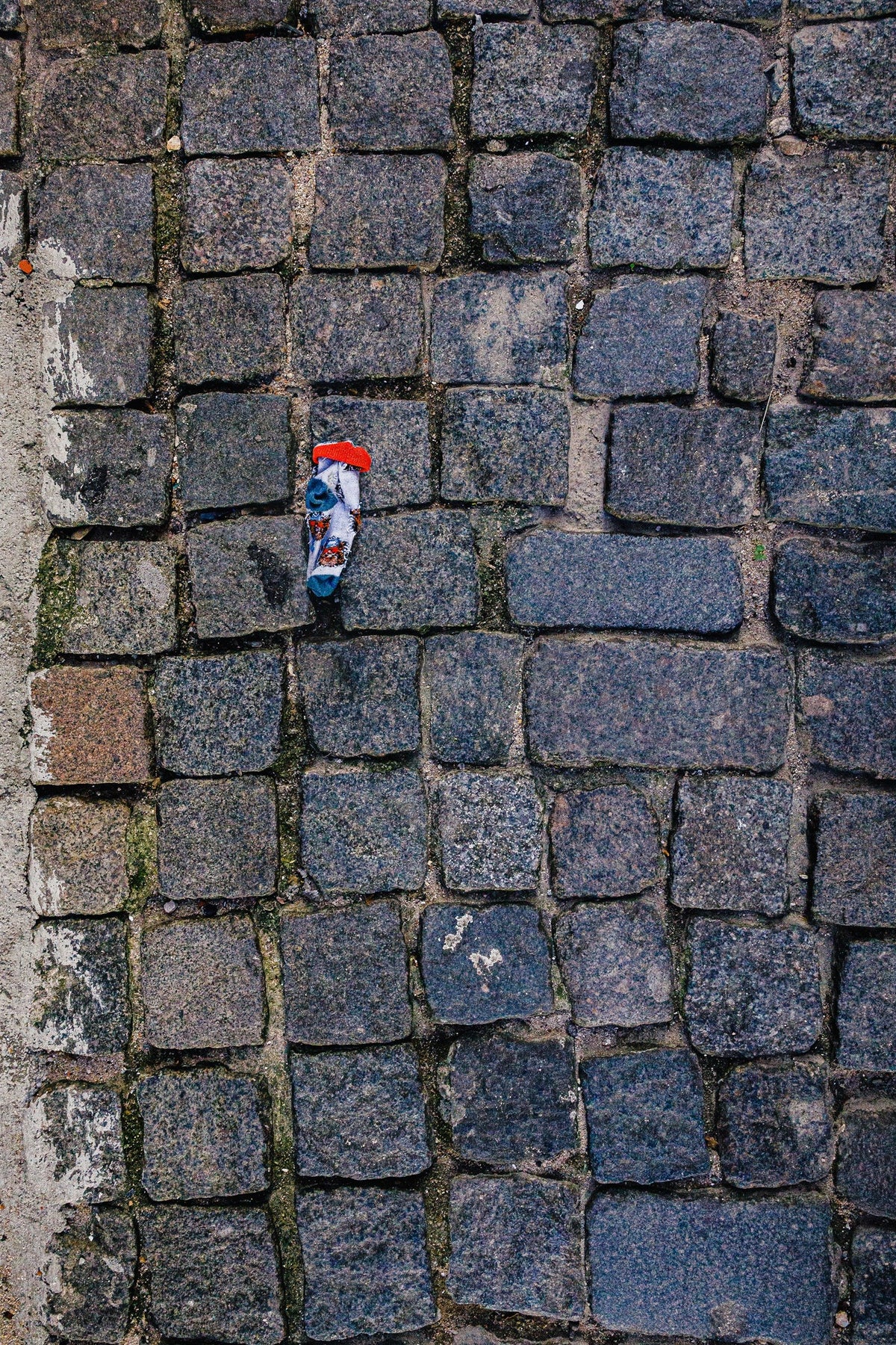 Portugal VI - The Lost Sock, a child's sock on a Portuguese street